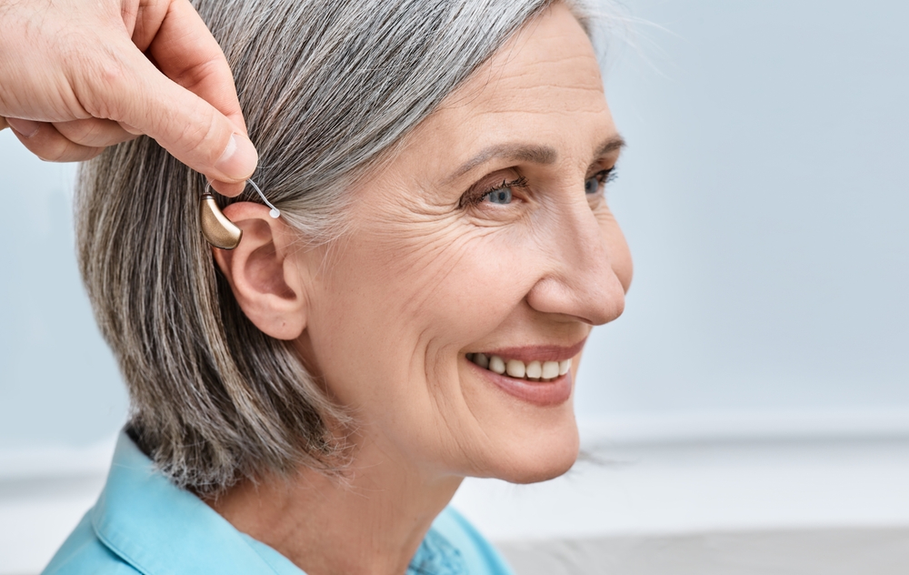Lady using hearing aids.
